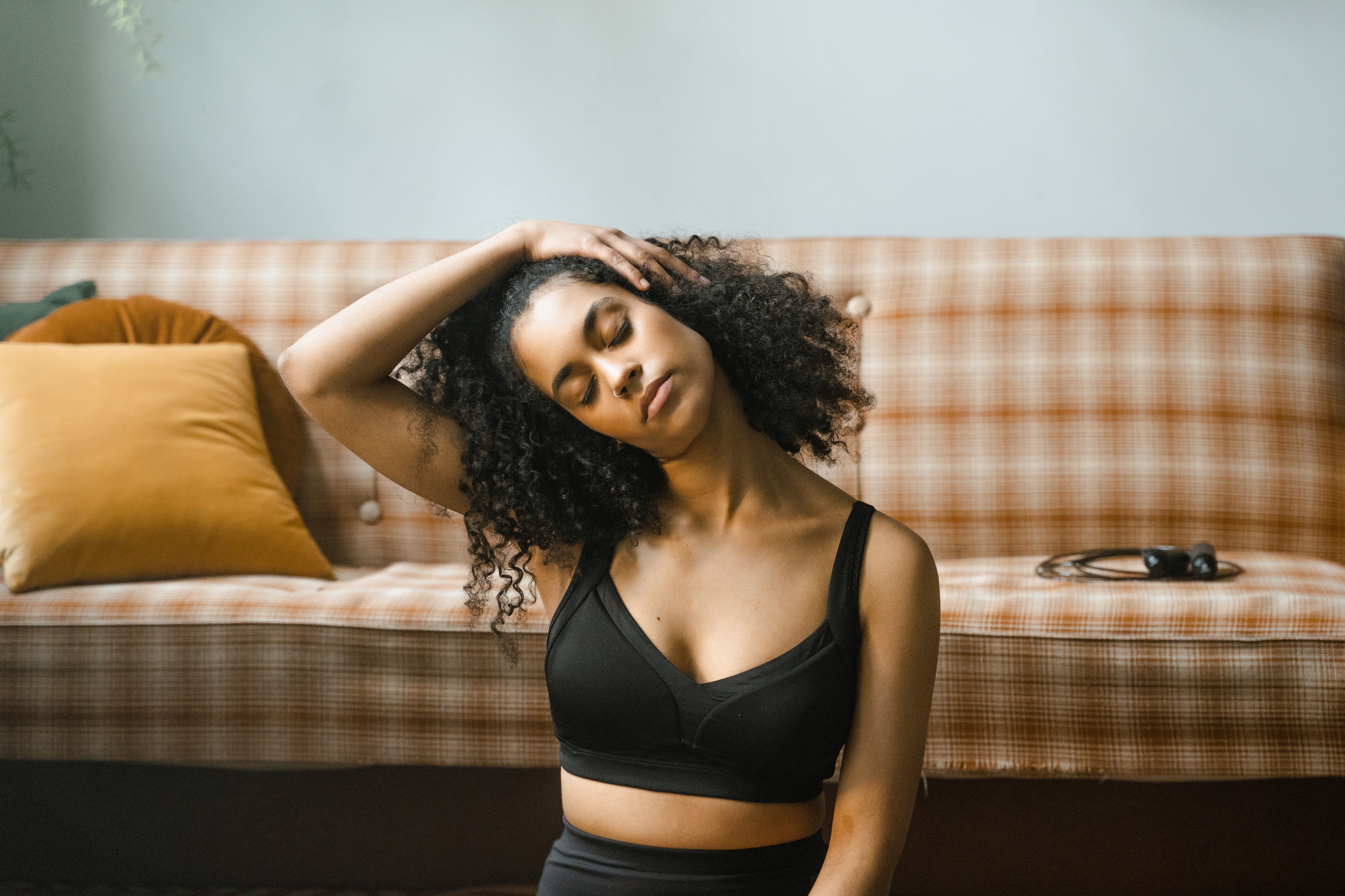 woman stretching neck at home